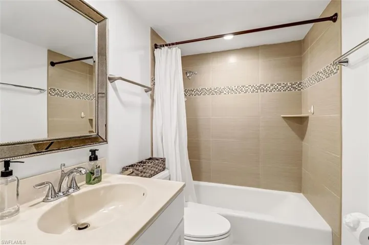 Full bathroom with vanity and shower / bath combination with curtain