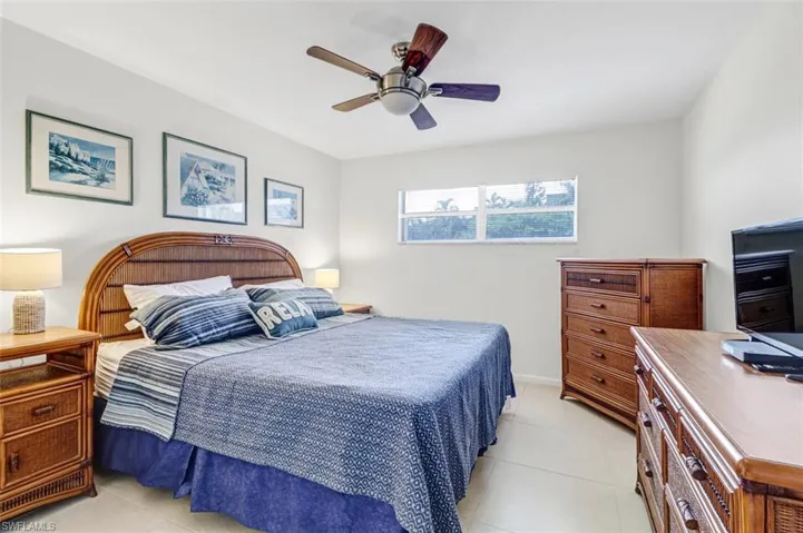Bedroom featuring light tile patterned floors and a ceiling fan