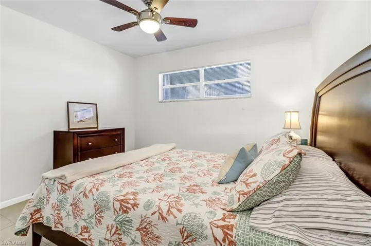 Bedroom featuring a ceiling fan and baseboards