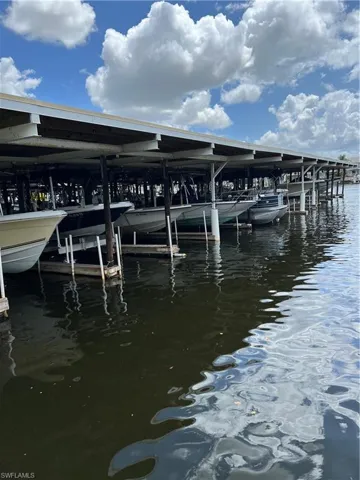 Dock featuring boat lift and a water view