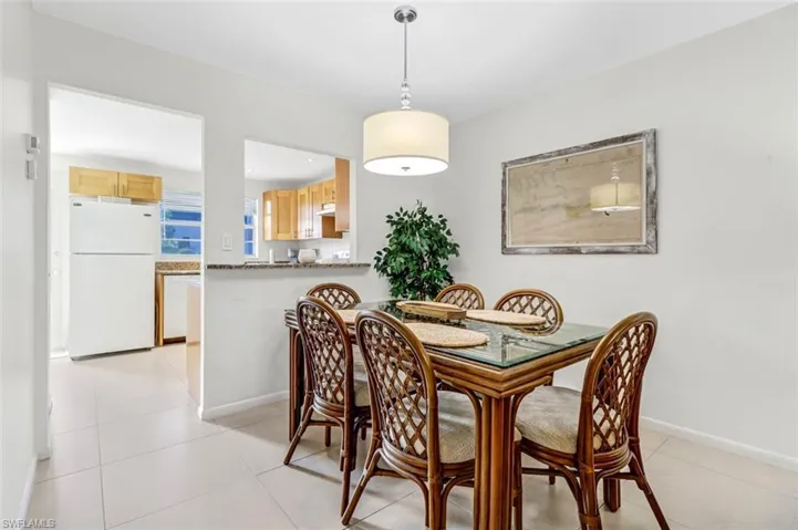 Dining space with light tile patterned floors