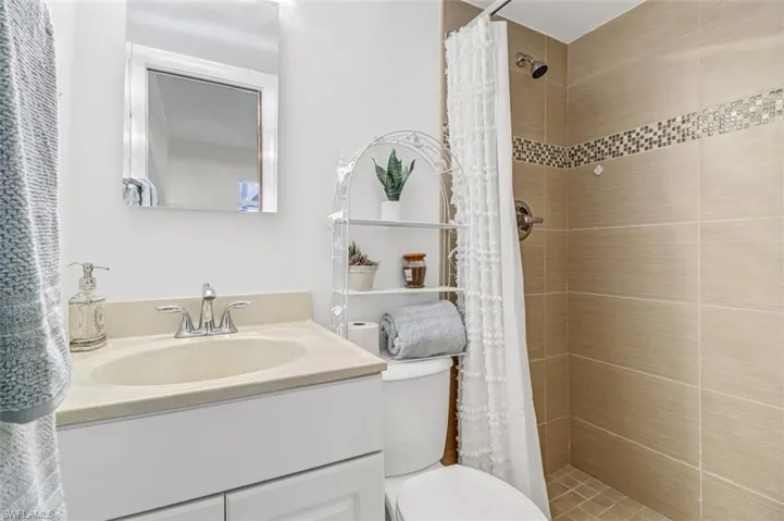 Full bathroom featuring vanity and tiled shower