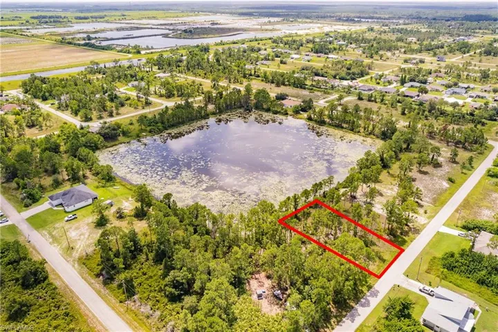 Aerial overview of property's location with property parcel outlined and a large body of water