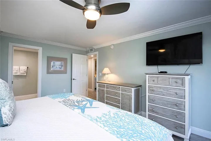 Bedroom featuring ceiling fan and ornamental molding