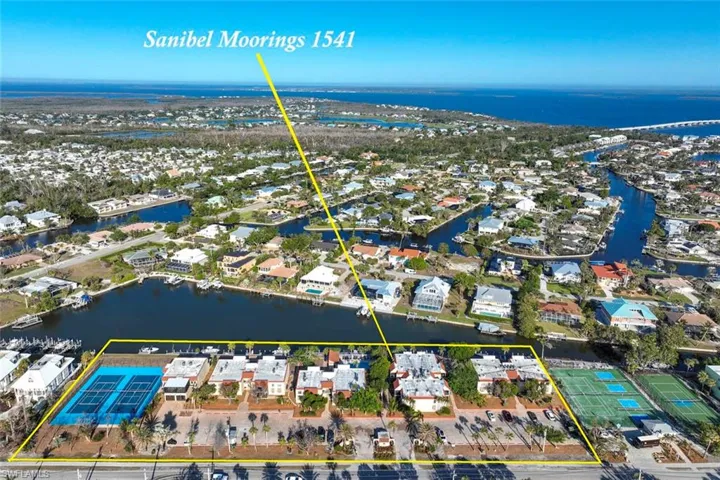 Birds eye view of property with a canal view