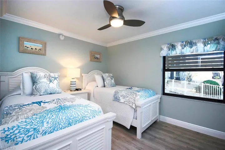 Bedroom with ceiling fan, crown molding, and light wood-LVP floors