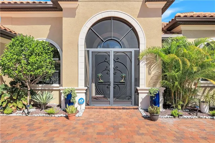 Doorway to property featuring stucco siding and a tiled roof