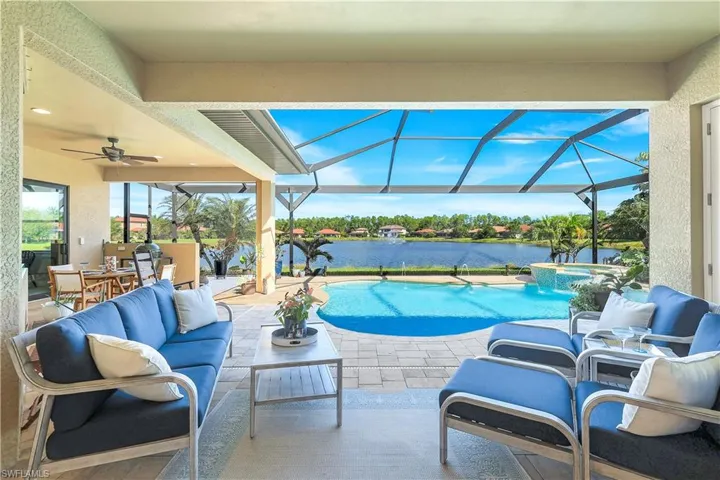 View of pool featuring outdoor lounge area, a patio area, a pool with connected hot tub, a sunroom, and ceiling fan