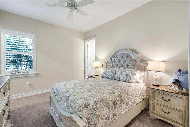 Bedroom featuring dark carpet and ceiling fan
