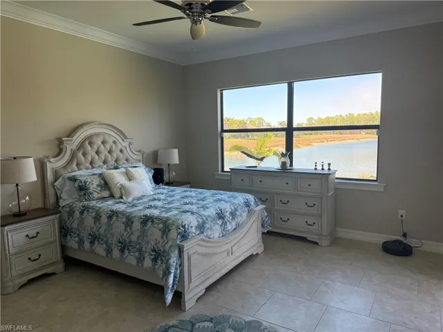 3rd Bedroom with ornamental molding, ceiling fan, a water view, and light tile patterned flooring