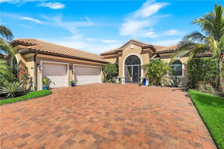 Mediterranean / spanish home with stucco siding, a garage, decorative driveway, and a tiled roof