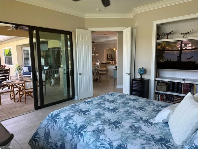 3rd Bedroom with ornamental molding, access to exterior, light tile patterned floors, and ceiling fan