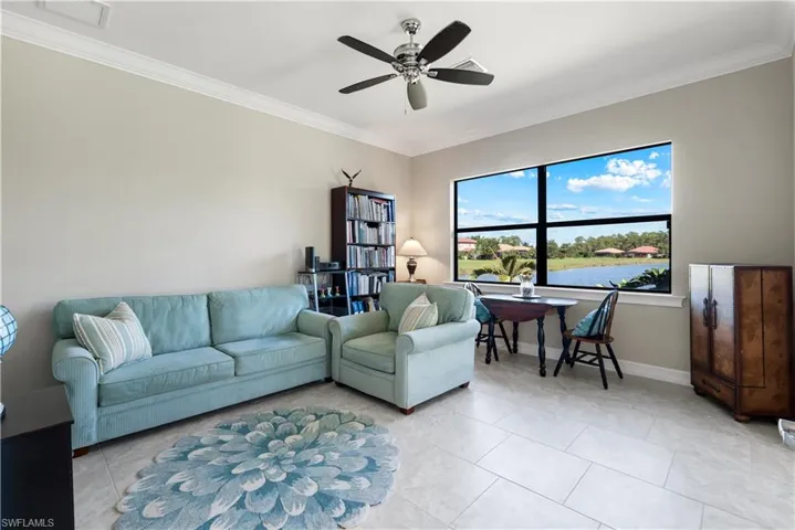 3rd Bedroom staged as sitting room - light tile patterned floors, and ceiling fan
