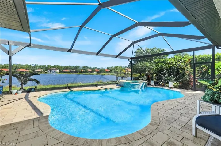 View of pool featuring panoramic screen for unobstructed water view, spa, and lanai door leading to a "Secret Garden" with fountain.