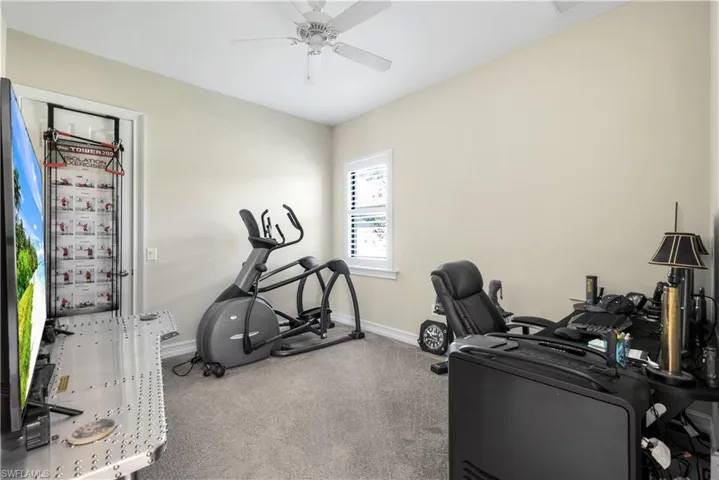4th bedroom Carpeted office space featuring baseboards and ceiling fan