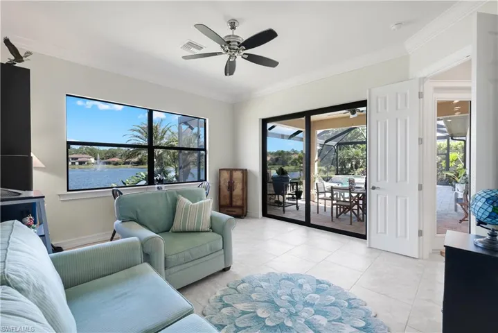 3rd Bedroom staged as sitting a water view, crown molding, and light tile patterned floors