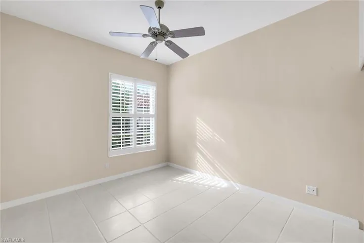 Light-toned walls with a white ceiling fan and light fixture