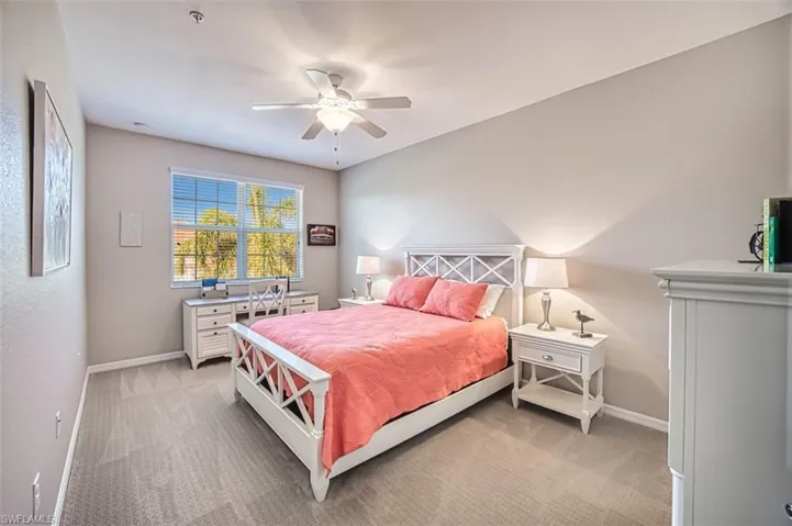 Carpeted bedroom with ceiling fan