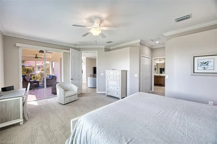Bedroom featuring ceiling fan, access to exterior, ornamental molding, light colored carpet, and a closet
