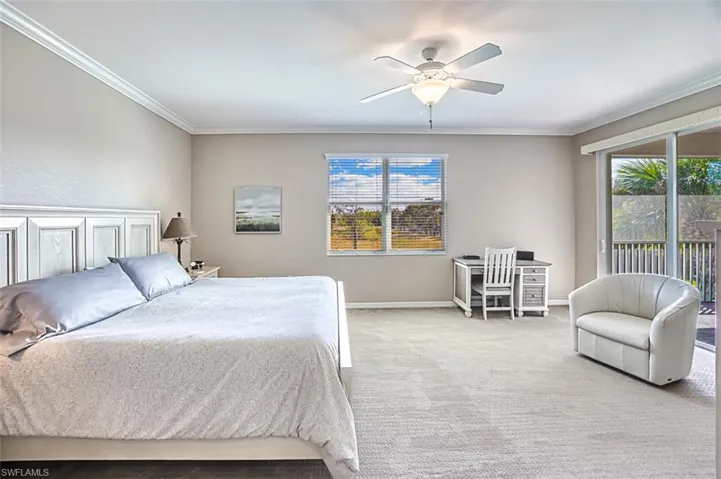 Bedroom with light carpet, multiple windows, access to exterior, and ceiling fan