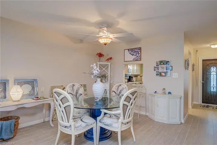 Dining room featuring wood finish floors and ceiling fan