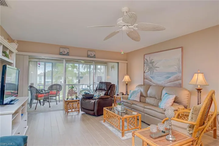 Living room with light wood-style floors and ceiling fan