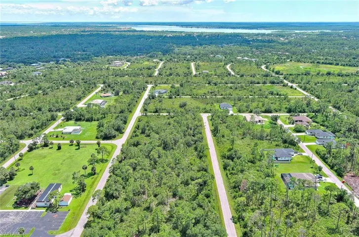 Aerial view of a heavily wooded area and a nearby body of water