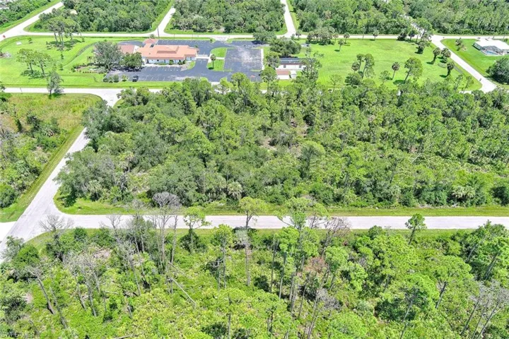 Aerial view of property's location with a forest