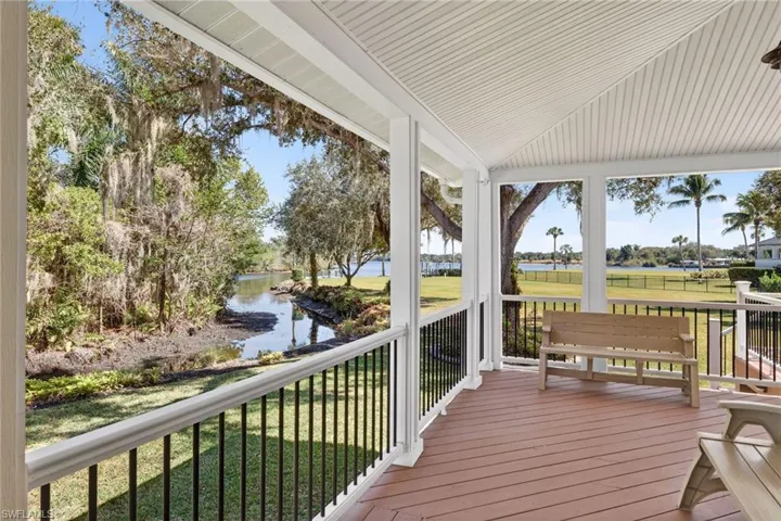 Deck featuring a river view and a lawn