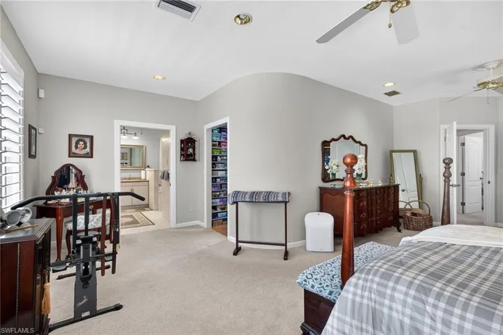 2nd level Primary Suit with carpet floors, recessed lighting, connected bathroom, and ceiling fan