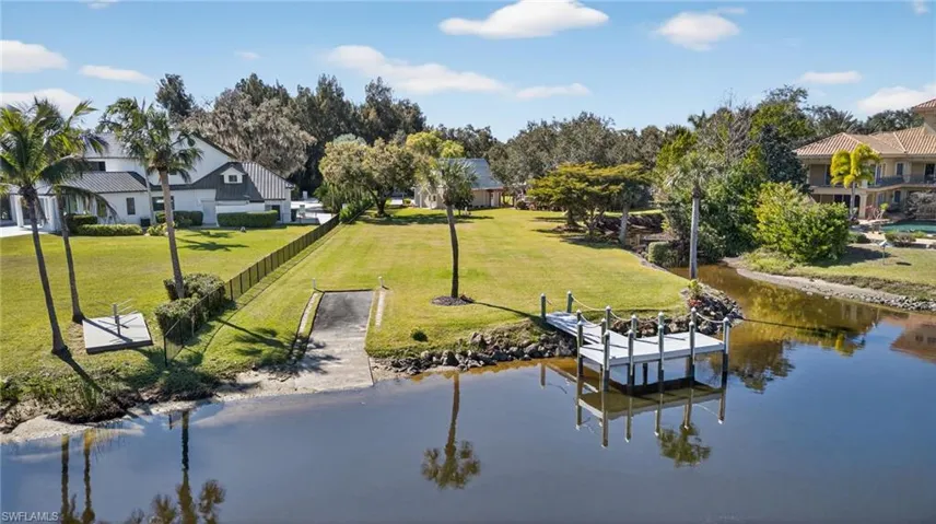 Dock area featuring a yard and a river view