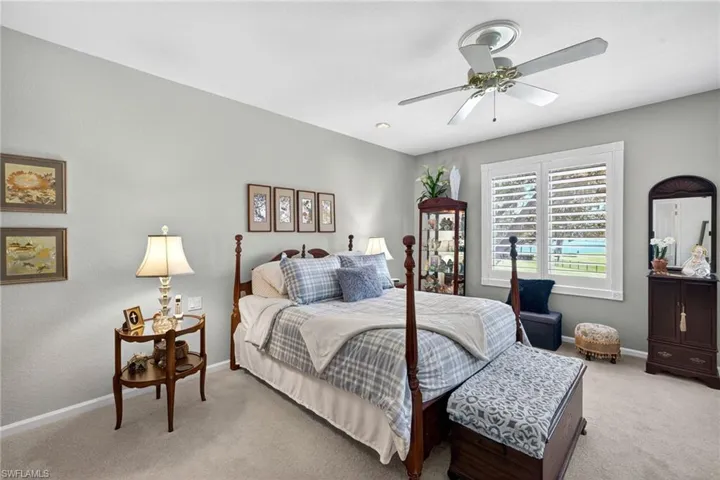 2nd Level Primary Suit with light carpet and ceiling fan