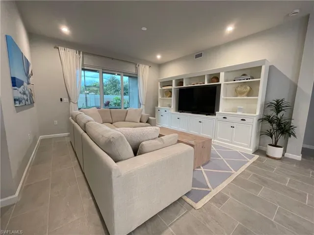 Living area with recessed lighting and baseboards