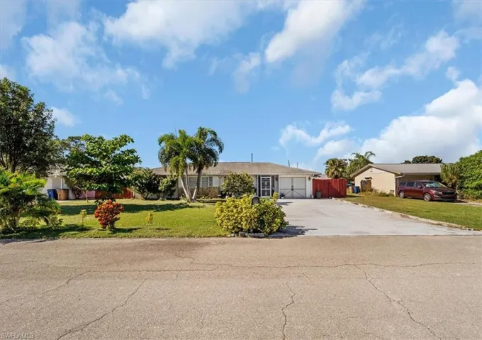 Ranch-style home with driveway and a garage