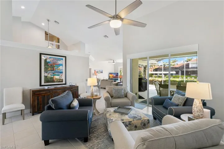 Living room with high vaulted ceiling, and ceiling fan