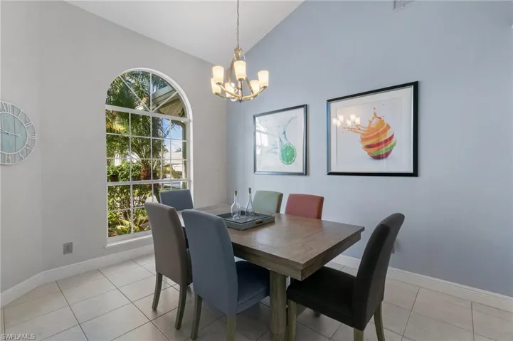 Dining area featuring high vaulted ceiling