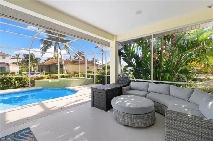 swimming pool with an outdoor living space, a lanai, and patio