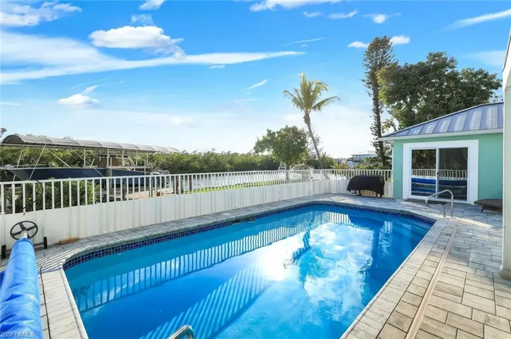 View of pool featuring patio surround and a fenced backyard