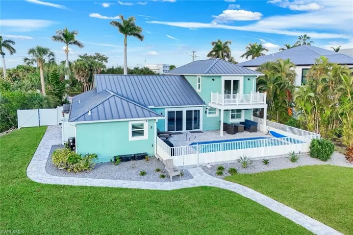 Back of property featuring outdoor furniture, a fenced backyard, a patio area, and a standing seam roof