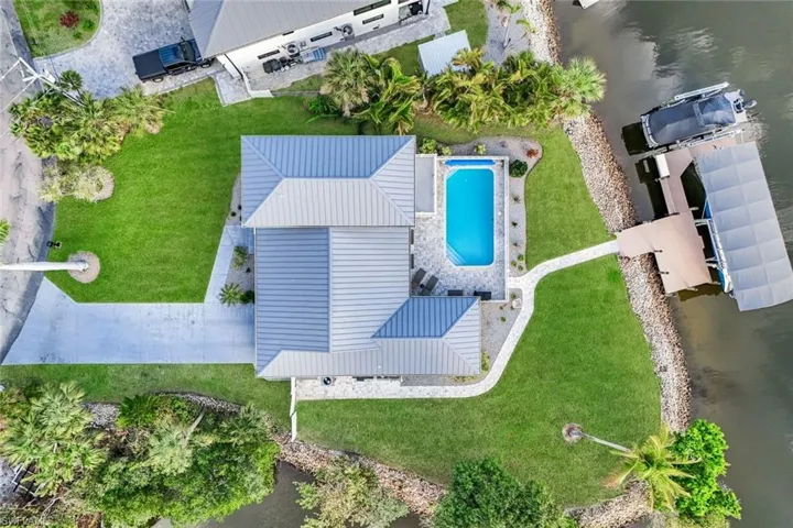 Drone / aerial view of a pool and a large body of water