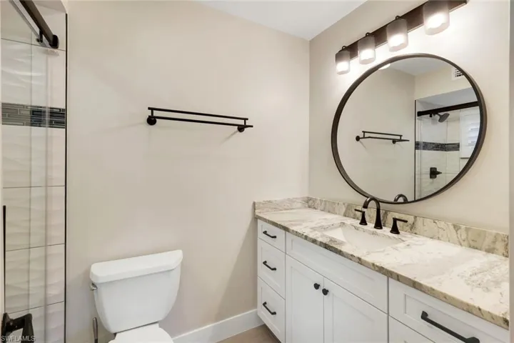 Bathroom with a shower stall and vanity