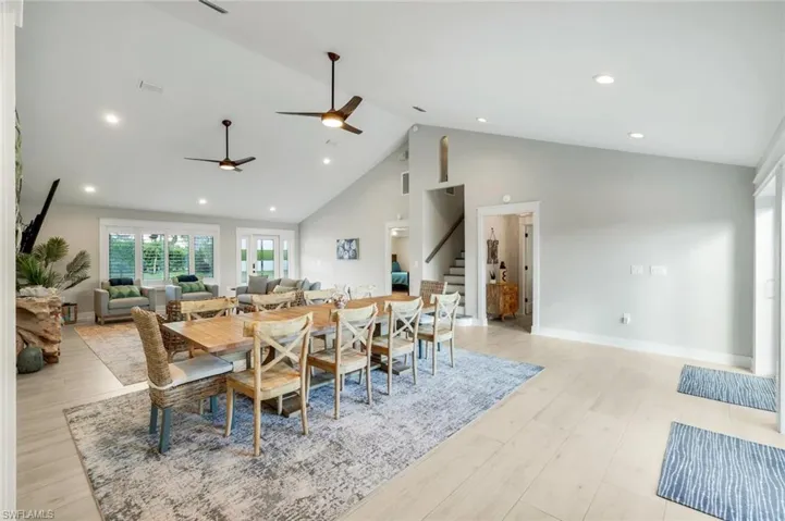 Dining space with light wood-type flooring, recessed lighting, and vaulted ceiling