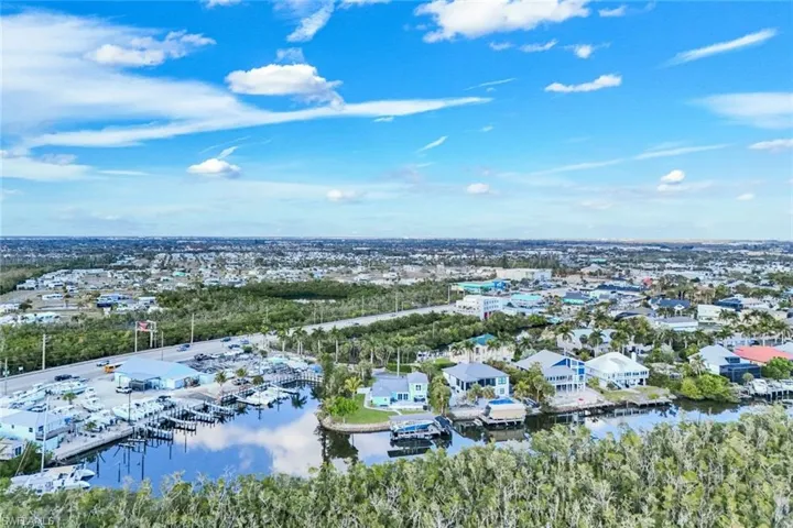 Aerial view of residential area featuring a large body of water and numerous boat docks