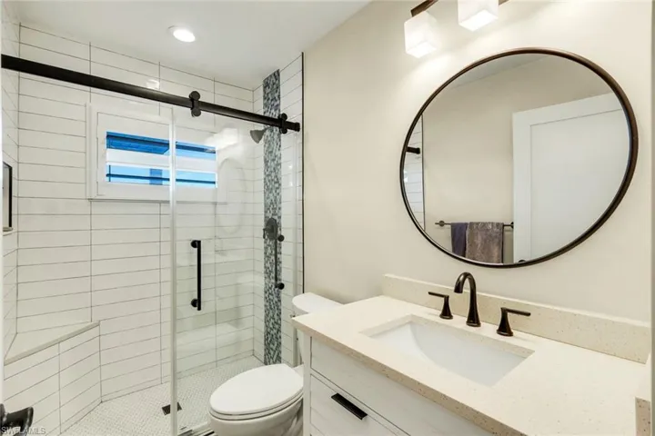 Full bath featuring vanity and a stall shower