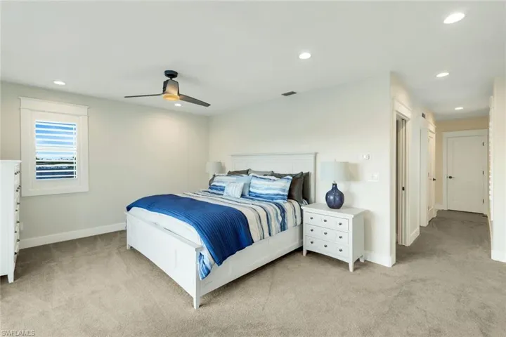 Bedroom featuring recessed lighting, light colored carpet, and a ceiling fan