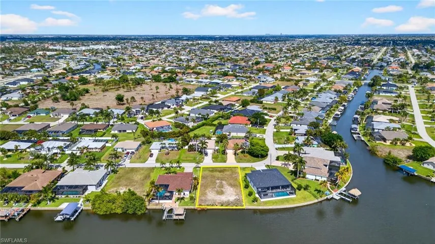 Aerial perspective of suburban area featuring a nearby body of water