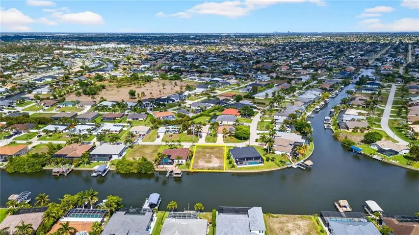 Aerial overview of property's location with nearby suburban area and a nearby body of water