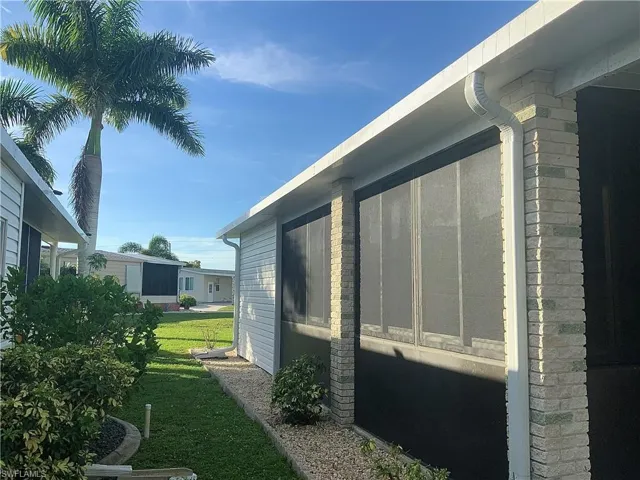 Side screened lanai view to backyard