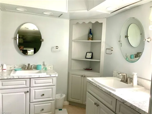 Owner bath w/separate vanities & storage
