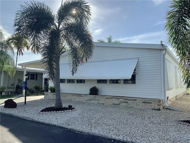 Exterior front of home w/shutters in place.